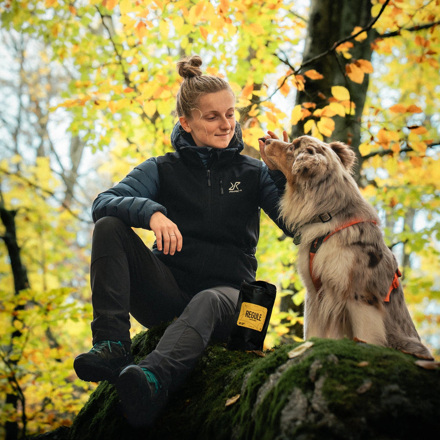 Dog trainer giving her australian shepherd Regule dog treats