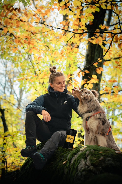 Dog trainer giving her australian shepherd Regule dog treats